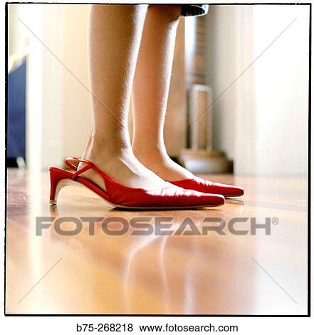 Small feet in big red shoes View Large Photo Image Stock Photo - Small feet in big red shoes. Fotosearch