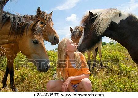 Stock Photo - Small girl in a pony herd.. Fotosearch