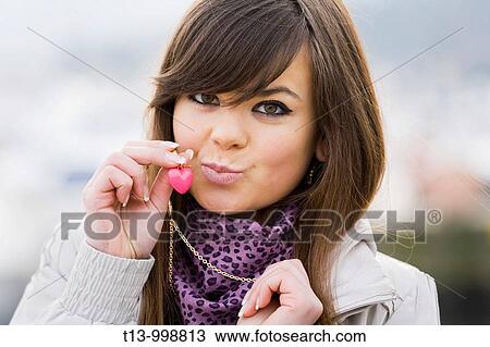 Small heart on necklace, attractive young woman portrait View Large Photo Image Stock Image - Small heart on necklace, attractive young woman portrait. Fotosearch