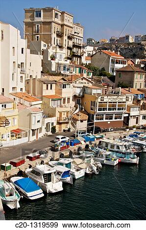 Stock Photo - Small homes and high building, typical harbour of the Vallon des Auffes, coast road/corniche, Marseille, Bouches du Rhone, 13, France.. Fotosearch