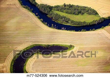 Stock Photograph - Small rivers in agricultural landscape, meandring, aerial view. Sm? land. Sweden. Fotosearch