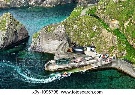 Small sheltered harbour at Dunquin services boats for the Blasket Islands West tip of the Dingle peninsula, Co Kerry, Ireland View Large Photo Image Stock Photo - Small sheltered harbour at Dunquin services boats for the Blasket Islands West tip of the Dingle peninsula, Co Kerry, Ireland. Fotosearch