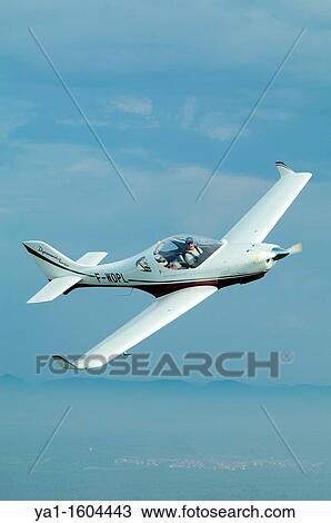 Small sport European LSA Aerospool Dynamic Turbo plane flying over France. Back the german Black Forest mountains range View Large Photo Image Stock Image - Small sport European LSA Aerospool Dynamic Turbo plane flying over France. Back the german Black Forest mountains range. Fotosearch