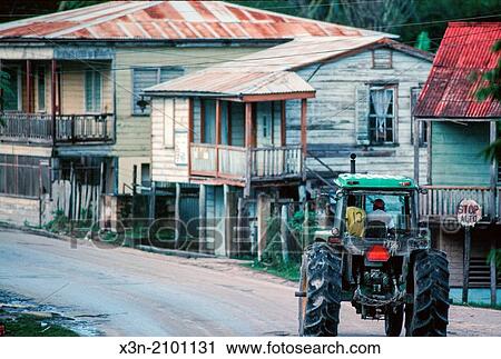 Small towin with men riding in tractor in Northern Belize. View Large Photo Image Stock Image - Small towin with men riding in tractor in Northern Belize.. Fotosearch