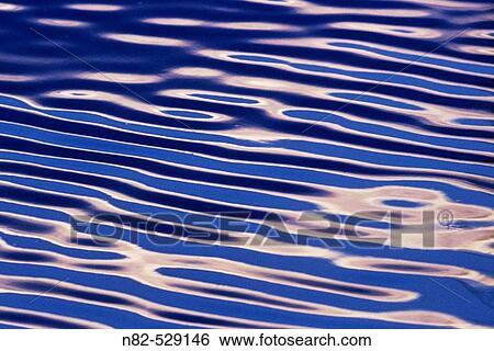 Stock Photograph - Small waves in sunset - Fr? nkisches Seenland, Franconia/Bavaria/Germany. Fotosearch