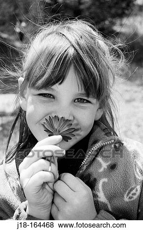 Stock Photo - Smelling the flower. Fotosearch