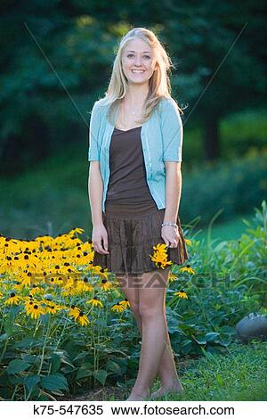 Smiling 17 year old Caucasian blonde teenager with black-eyed susans flowers View Large Photo Image Stock Photography - Smiling 17 year old Caucasian blonde teenager with black-eyed susans flowers. Fotosearch