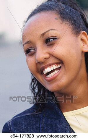 Smiling African-American teenage girl looking away from camera View Large Photo Image Stock Photo - Smiling African-American teenage girl looking away from camera. Fotosearch