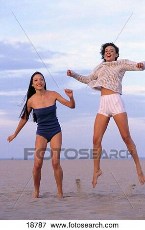 Stock Photo - Smiling and jumping girls. Fotosearch
