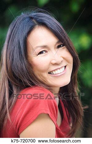 Stock Image - Smiling Asian American woman. Fotosearch