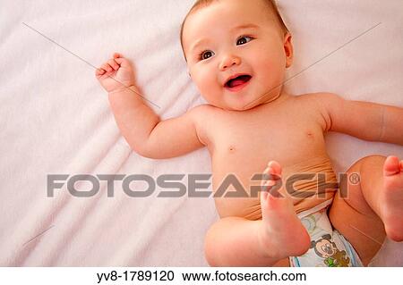 Smiling baby girl in diapers View Large Photo Image Stock Image - Smiling baby girl in diapers. Fotosearch