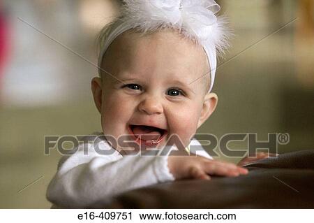 Smiling baby with a bow on head View Large Photo Image Stock Image - Smiling baby with a bow on head. Fotosearch