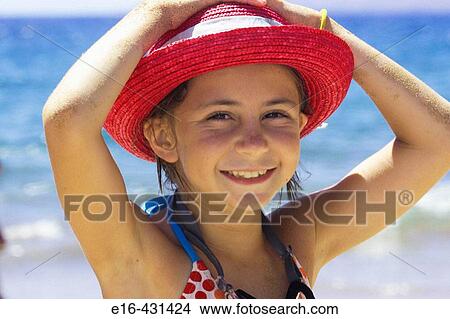 Smiling beach girl with pink hat. View Large Photo Image Picture - Smiling beach girl with pink hat.. Fotosearch