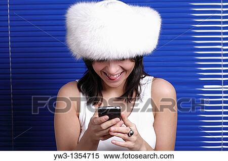 Smiling beautiful woman in hat talking by phone Beautiful with telephone, headset, headphones series View Large Photo Image Stock Photography - Smiling beautiful woman in hat talking by phone Beautiful with telephone, headset, headphones series. Fotosearch