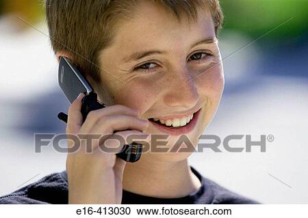 Smiling boy on cell phone. View Large Photo Image Stock Image - Smiling boy on cell phone.. Fotosearch