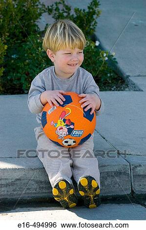 Stock Photograph - Smiling boy with ball. Fotosearch