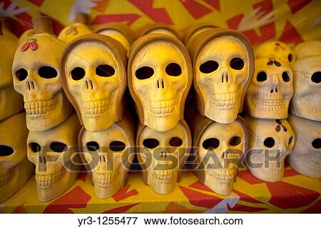 Stock Photo - Smiling ceramic skulls for sale in Mexico City.. Fotosearch