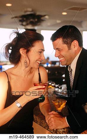 smiling couple at a bar with cocktail View Large Photo Image Stock Photo - smiling couple at a bar with cocktail. Fotosearch