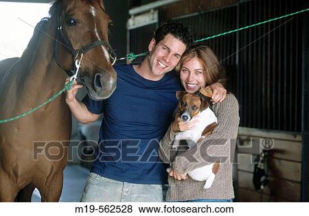 smiling couple in a horse stable View Large Photo Image Stock Photo - smiling couple in a horse stable. Fotosearch