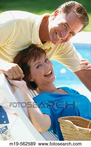 smiling couple poolside View Large Photo Image Stock Photo - smiling couple poolside. Fotosearch