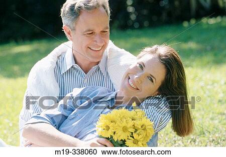 smiling couple with flower boquet View Large Photo Image Stock Image - smiling couple with flower boquet. Fotosearch