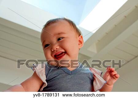 Stock Image - Smiling eight months old baby. Fotosearch