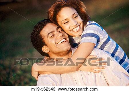 Stock Image - smiling, embracing couple. Fotosearch