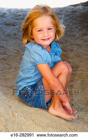 Stock Image - smiling girl at the beach. Fotosearch