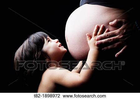 smiling girl embracing pregnant belly, Sevilla, Spain, Europe View Large Photo Image Stock Image - smiling girl embracing pregnant belly, Sevilla, Spain, Europe. Fotosearch