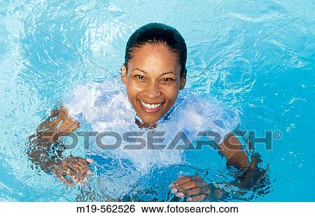 smiling girl in a pool View Large Photo Image Stock Photograph - smiling girl in a pool. Fotosearch