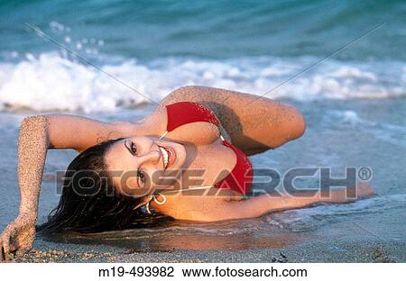 smiling girl lying on the beach View Large Photo Image Stock Image - smiling girl lying on the beach. Fotosearch