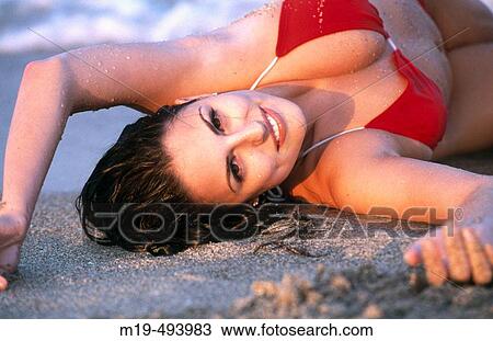 smiling girl lying on the beach View Large Photo Image Stock Image - smiling girl lying on the beach. Fotosearch