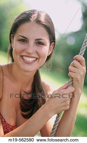 smiling girl on a rope swing View Large Photo Image Stock Image - smiling girl on a rope swing. Fotosearch