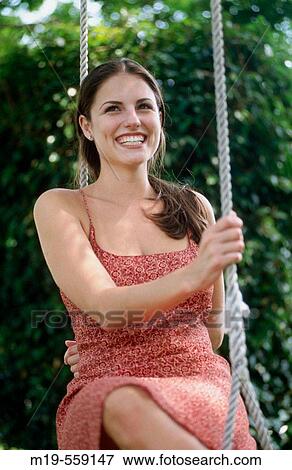 smiling girl on a swing View Large Photo Image Stock Photo - smiling girl on a swing. Fotosearch