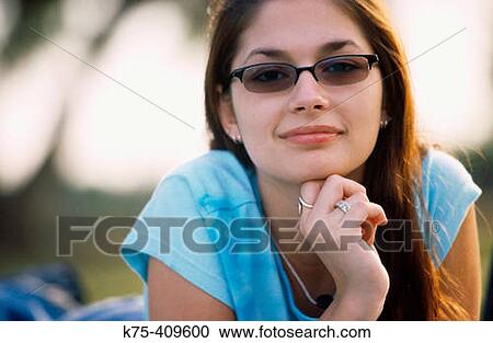 Smiling girl wearing sunglasses View Large Photo Image Stock Image - Smiling girl wearing sunglasses. Fotosearch