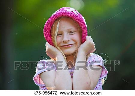 Stock Image - Smiling girl with hat. Fotosearch