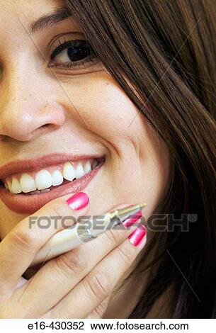Smiling Hispanic businesswoman holding pen near face View Large Photo Image Stock Image - Smiling Hispanic businesswoman holding pen near face. Fotosearch