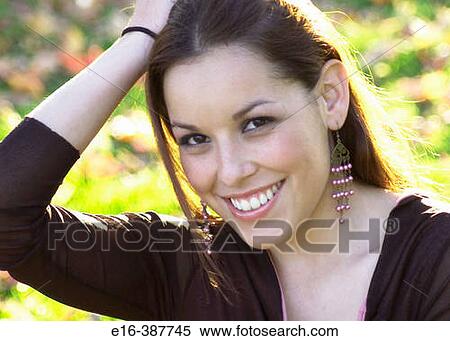 Smiling Latin lady with hand in hair View Large Photo Image Stock Photography - Smiling Latin lady with hand in hair. Fotosearch