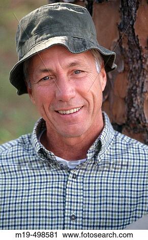 smiling man in a floppy hat View Large Photo Image Stock Image - smiling man in a floppy hat. Fotosearch