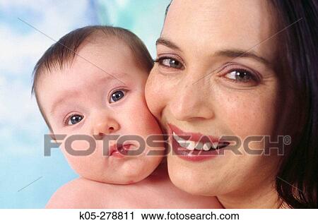 Stock Image - Smiling mother with four month old infant. Fotosearch
