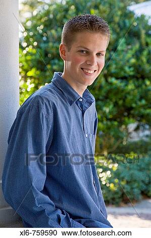 Stock Image - Smiling teenage boy looking at camera. Fotosearch