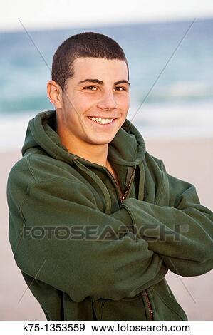 Stock Photo - Smiling teenager at the beach. Fotosearch