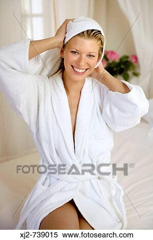 Stock Photography - Smiling woman drying her hair with a towel. Fotosearch