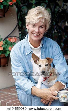 smiling woman holding her pet View Large Photo Image Stock Image - smiling woman holding her pet. Fotosearch