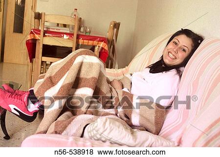 Smiling woman on sofa. View Large Photo Image Stock Photo - Smiling woman on sofa.. Fotosearch