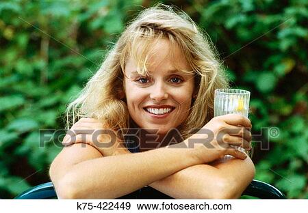 smiling woman with beverage in hand View Large Photo Image Stock Photo - smiling woman with beverage in hand. Fotosearch