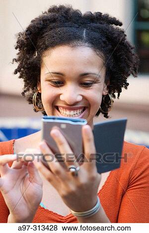 Smiling young Afro-Caribbean woman with palm calculator View Large Photo Image Stock Photo - Smiling young Afro-Caribbean woman with palm calculator. Fotosearch