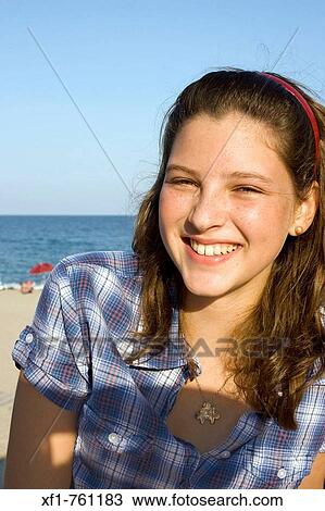 Smiling young girl on the beach View Large Photo Image Stock Image - Smiling young girl on the beach. Fotosearch