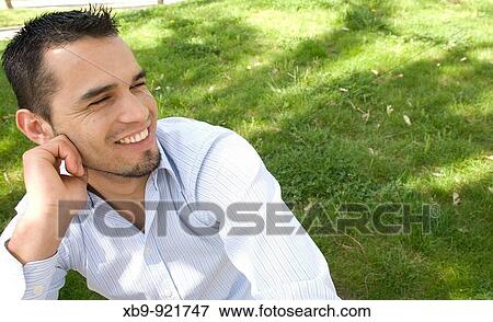 Smiling young Latino man View Large Photo Image Stock Photo - Smiling young Latino man. Fotosearch