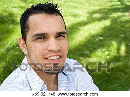 Stock Photo - Smiling young Latino man. Fotosearch